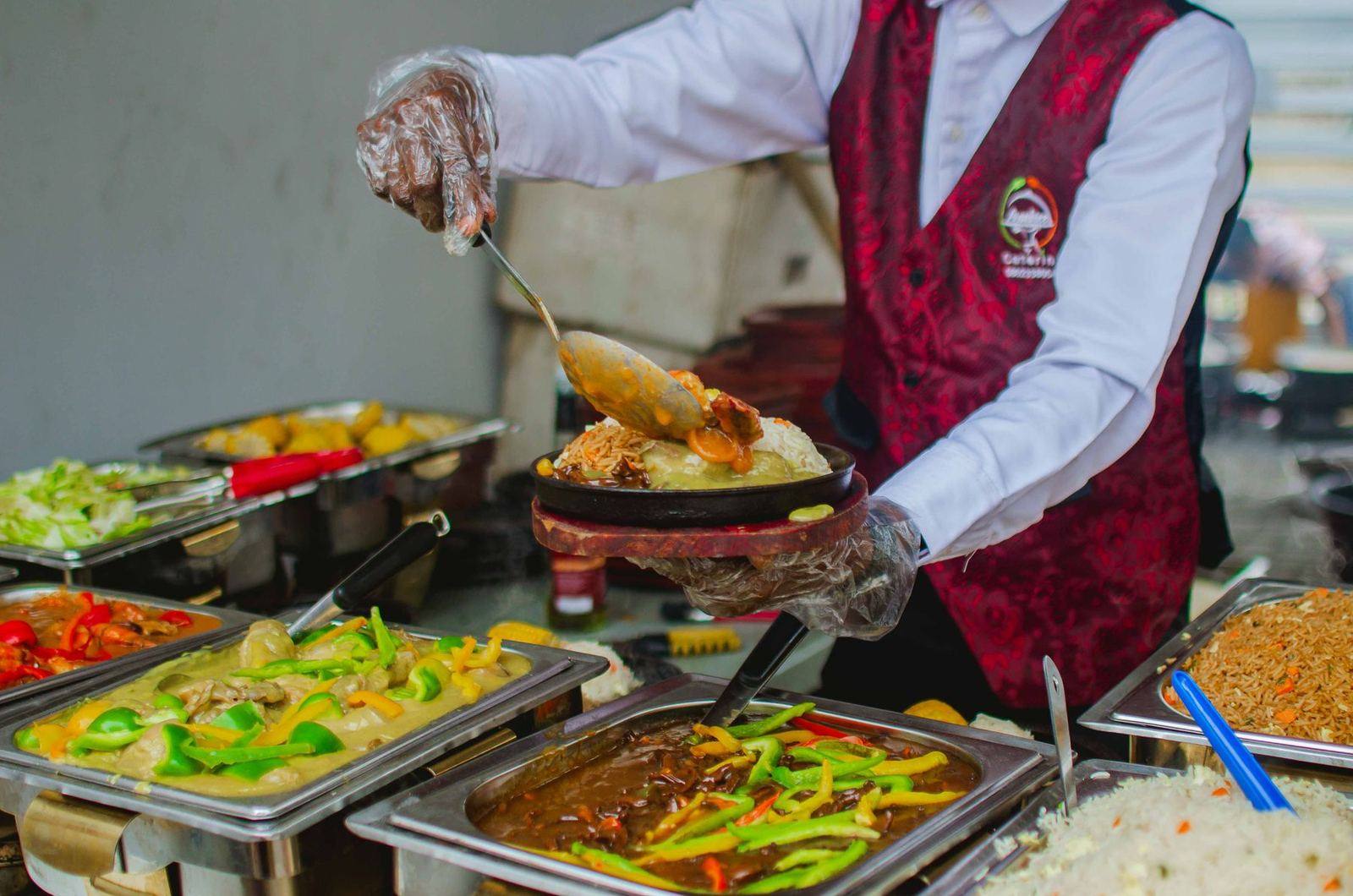 Chef serving dishes at buffet