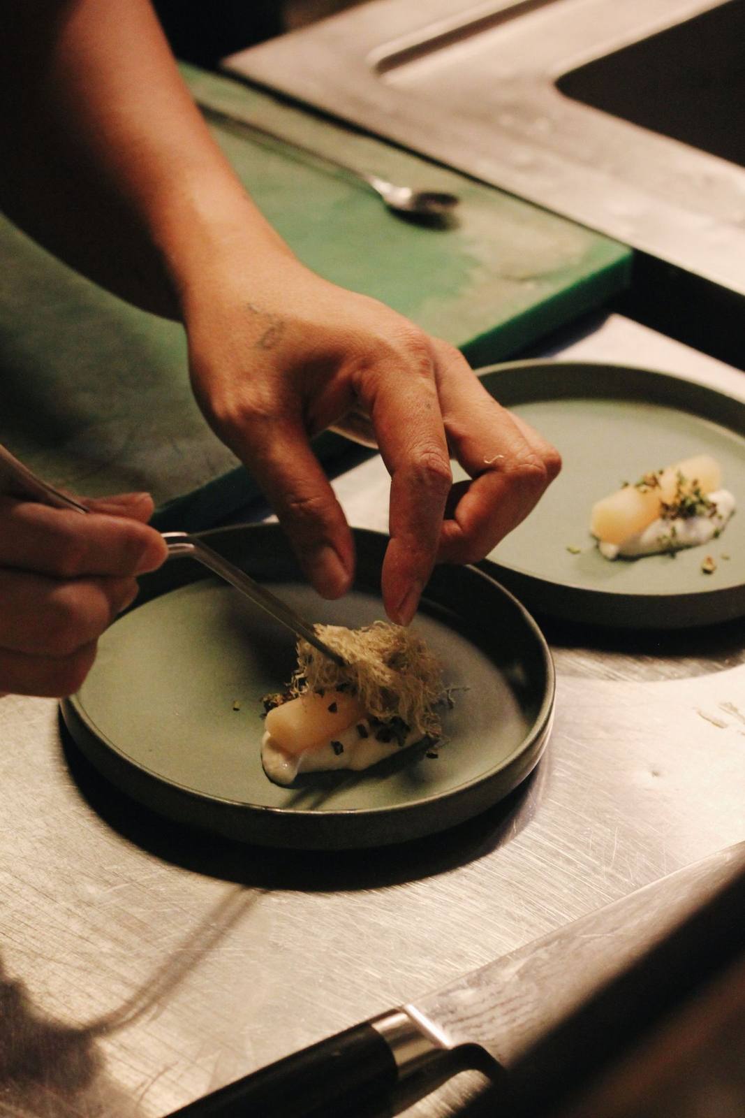 A chef plating a course at a RASA chef's table